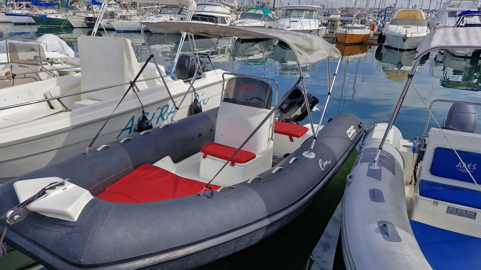 CNC RIB boat rental Alghero anchored at sunrise